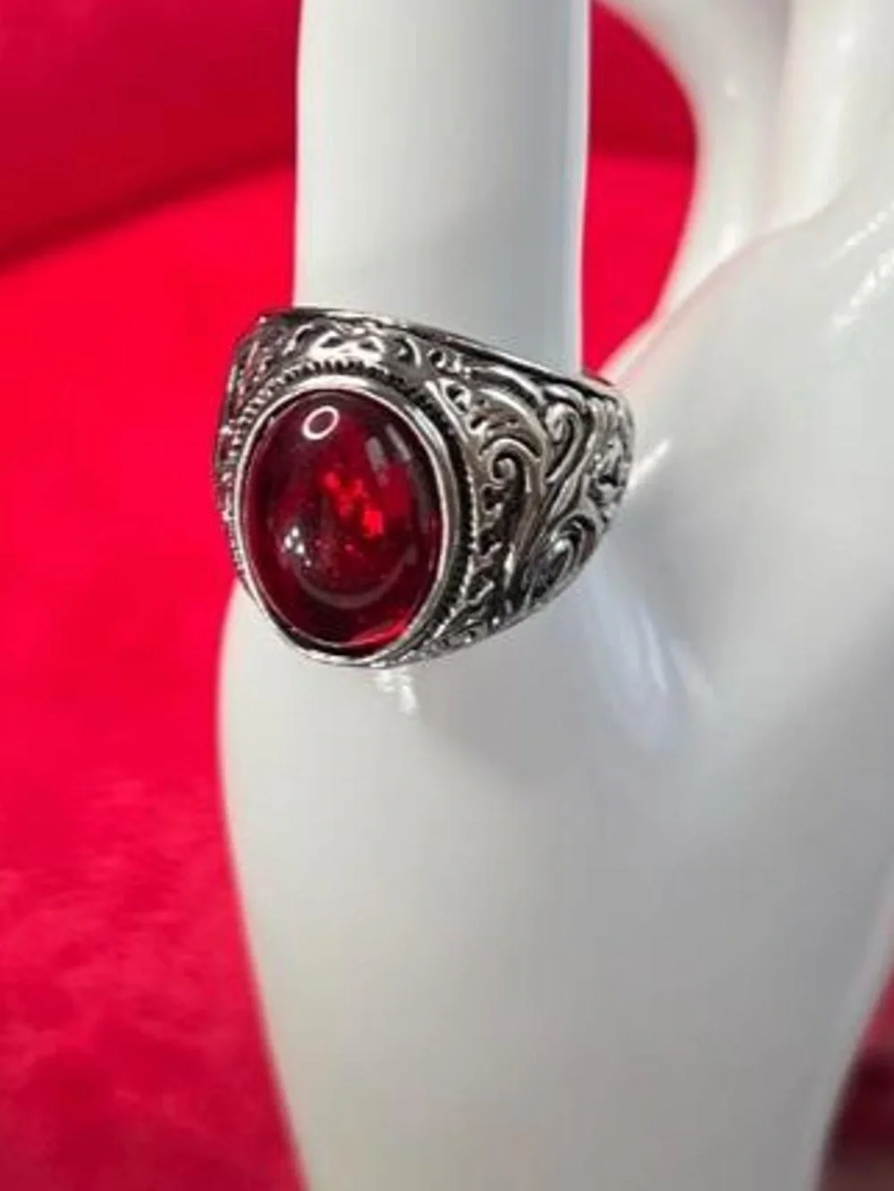 Red ruby gemstone ring with silver filigree detailing